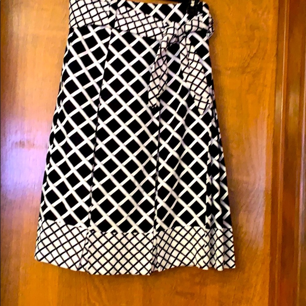 Black and white belted, pleated skirt.